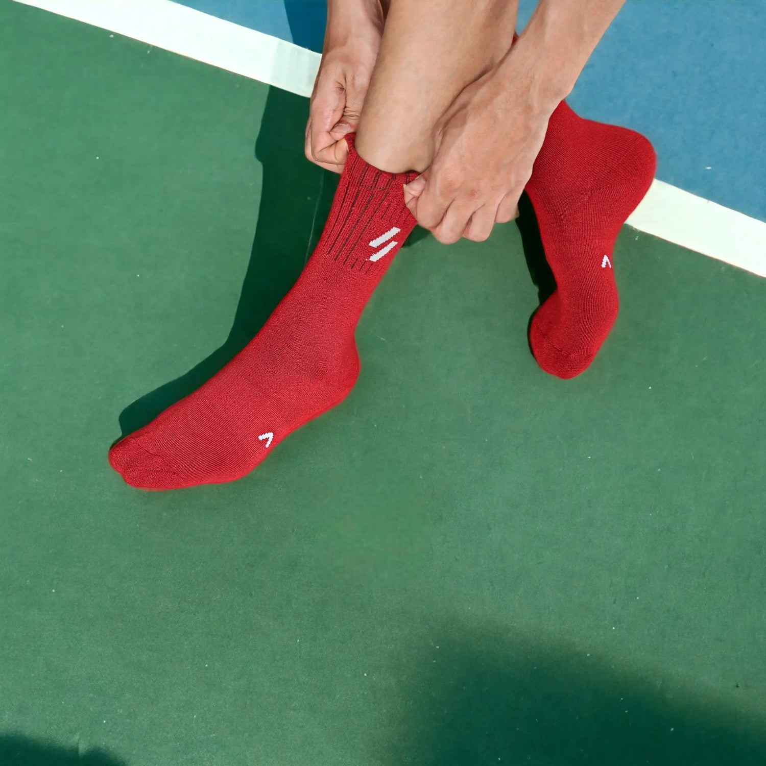 Athlete in red ATHL sports socks with compression band