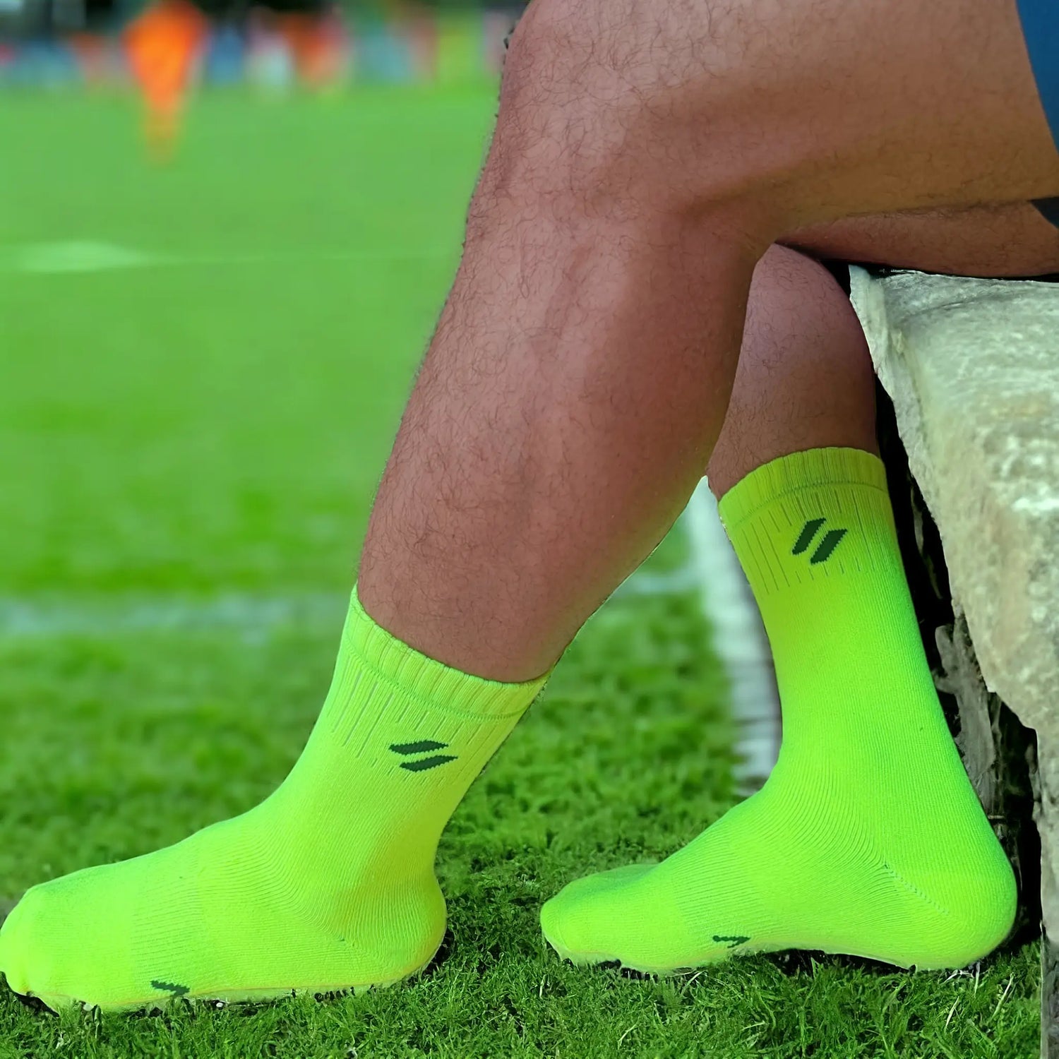 Athlete in ATHL neon green sports socks with elasticated cuff