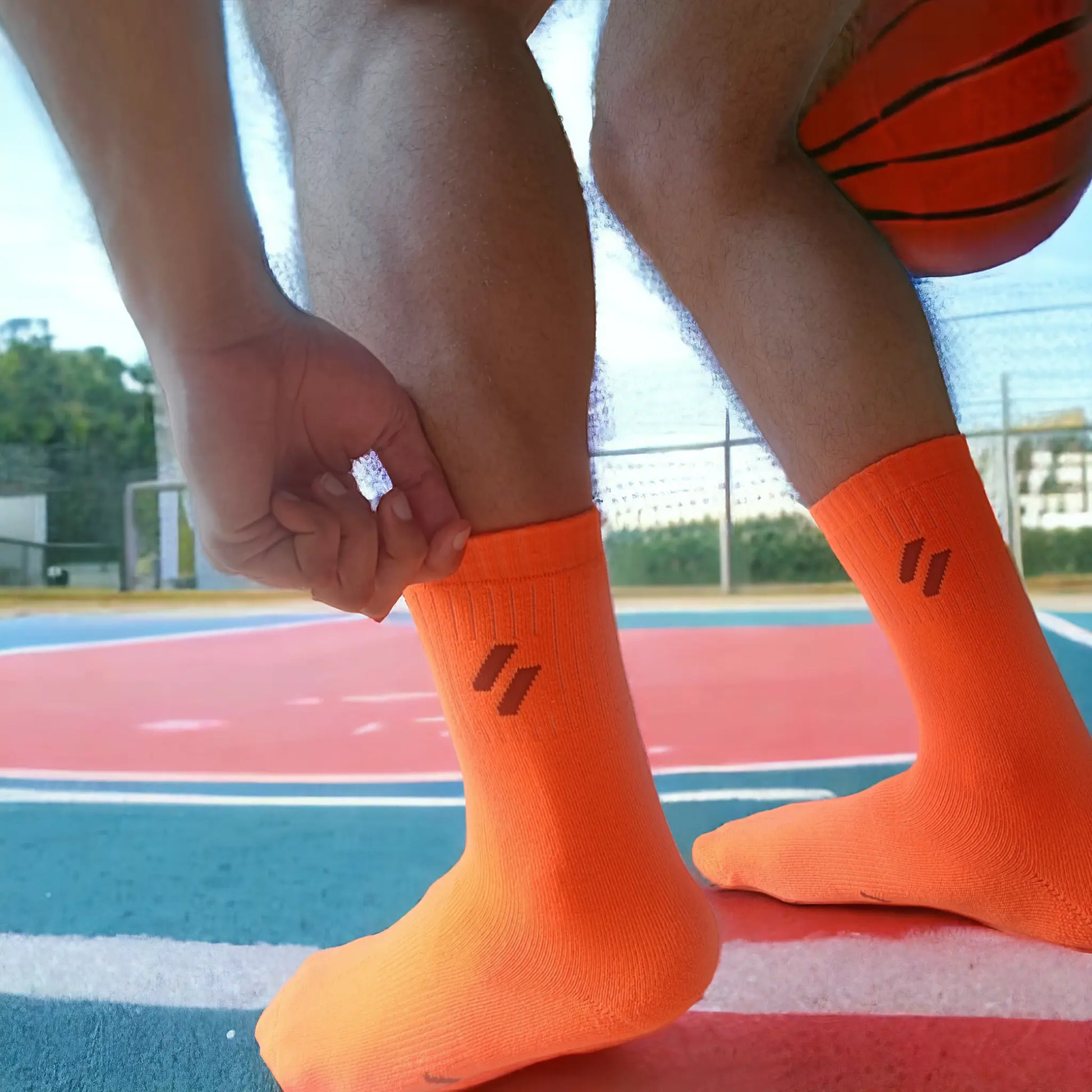 Neon orange sports socks on athlete playing basketball